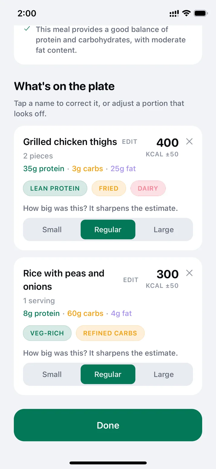 The plate broken into grilled chicken thighs and rice with peas, each with its own calories and portion size